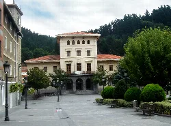 Ugao town hall building in Vizcaya with trees and benches in the square