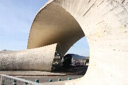 Modern curved concrete structure at Casar de Cáceres bus station.