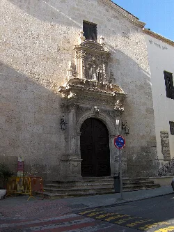 Convent facade with wooden door and ornate entrance details.
