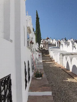 Path with white graves and blue sky in Casabermeja, Málaga.