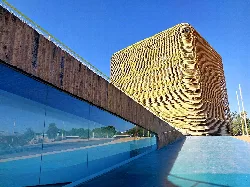 Modern wooden building with rectangular shape and reflective windows in Villanueva de la Serena.