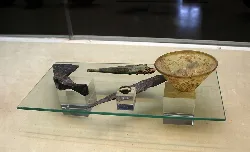 Ancient objects displayed on a glass shelf in the museum.