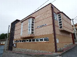 Town hall building with brick facade and large windows in La Colilla.