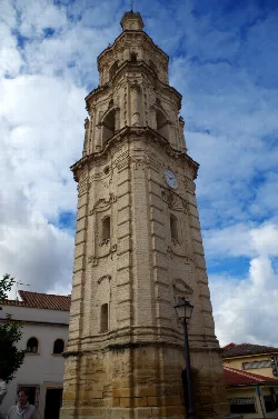 Clock Tower of Aguilar de la Frontera with cloudy sky.