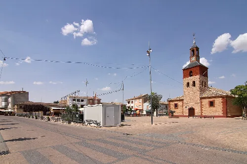 Plaza de España with church and buildings in Villafranca de los Caballeros.