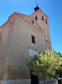 Brick church with tower and tree in Alameda de la Sagra.