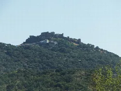 Castle on a hilltop with greenery in Montánchez.