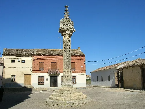 Stone judgment pillar with decorative top in the town square.