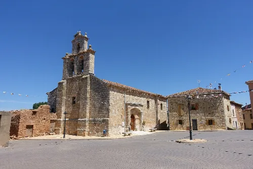 San Esteban Protomártir church in Torrepadre, Burgos, with tower and stone facade.