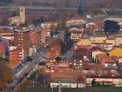 Aerial view of Venta de Baños with buildings and streets.