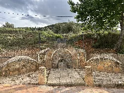 Fuente de piedra con arco y caño de agua en Peñas de San Pedro.