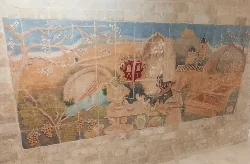 Ceramic mural showing farming, pottery, and town views in Agost.
