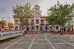 Town hall building with red details in Villanueva del Fresno.