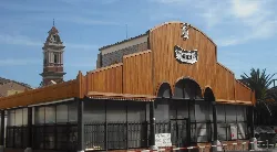 Market building with wooden structure and clock on the facade