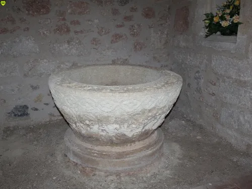 Stone baptismal font inside a church in Payo de Ojeda, Palencia.