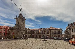 Town hall building with clock and tower in A Guarda's main square.