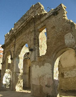 Ruins of an ancient temple with brick arches and damaged walls.