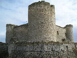 View of Pioz Castle with stone walls and tower.