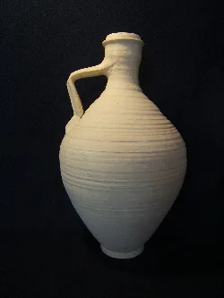 Weißer Keramikkrug mit Henkel und runder Form.