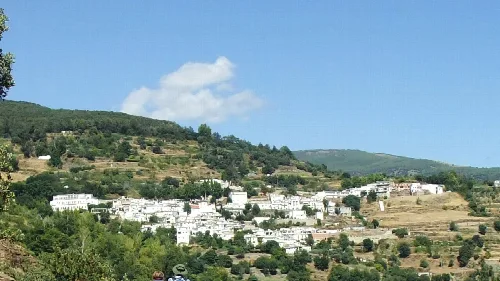 Blick auf Busquístar in Granada mit weißen Häusern und Bergen im Hintergrund.