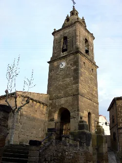 Stone tower of San Martín Church in Fonzaleche with clock and bell tower.