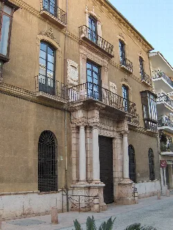 Facade of a palace with columns and balconies in Antequera.