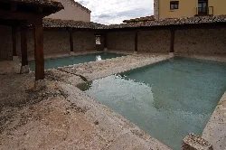 Washhouse with water pools and wooden structure in Fuentelcésped.