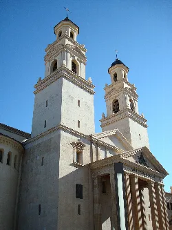 Facade of a basilica with two towers and columns in Villarreal.
