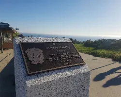 Plaque in Stephen Hawking Square at Cabo Fisterra with sea views.