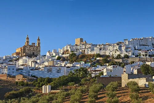 Landschaft von Olvera mit weißen Häusern und einer Kirche auf dem Hügel.