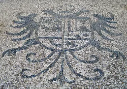 Shell mosaic coat of arms on the facade of San Miguel Arcángel church.