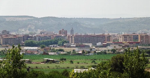 Urban landscape with buildings and mountains in the horizon