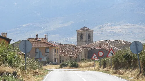 View of a village with church and houses from the road in Cerezo de Arriba.