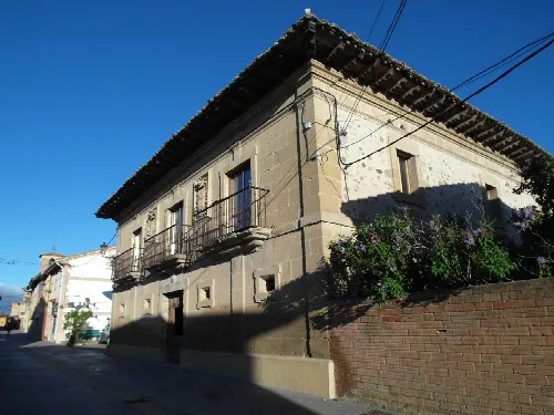 Stone building with balcony in Redecilla del Camino.