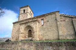 Stone church with tower and Romanesque arch in Valdeolea, Cantabria.