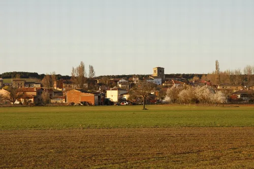 Rural landscape with houses, trees, and a church in Santa Inés, Burgos.