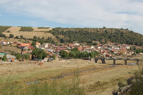 Ländliche Landschaft mit Häusern und Hügeln in Vegalatrave