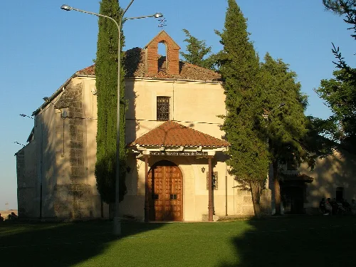 Small church with wooden door and bell tower in Mozoncillo.