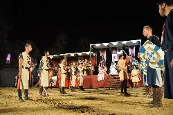 People in medieval costumes at an outdoor event in Alburquerque.