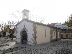 Small white hermitage with bell tower and stone walls in Candeleda.