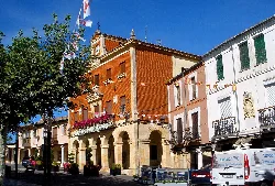 Main square with brick building and arches in Herrera de Pisuerga.