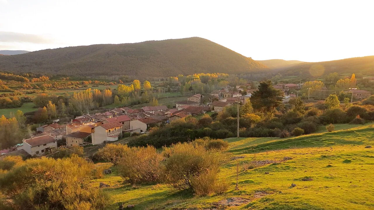 Autumn landscape with houses, trees, and mountains in Barbadillo de Herreros.
