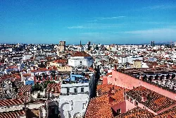 View of Badajoz city from Torre Espantaperros with buildings and blue sky.