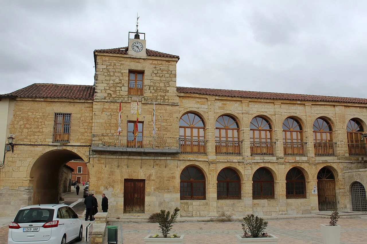 Town hall building with clock tower and arched windows.
