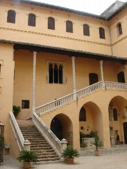 Facade of the Ducal Palace with stairs and columns in Gandía.