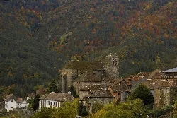 Ansó with Gothic church and houses in an autumn landscape.