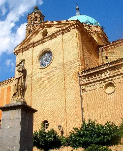 Church with blue dome and statue in the garden square in La Almunia de Doña Godina