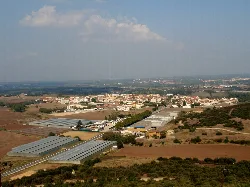 Panoramic view of the town and surroundings from a hill.