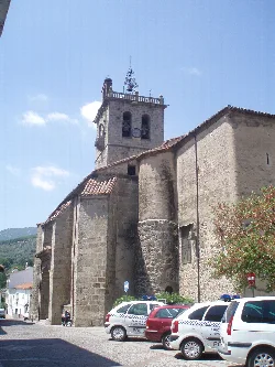 Church with tower and cars on the street in Arenas de San Pedro
