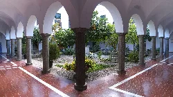 Courtyard with arches and gardens in Los Santos de Maimona.